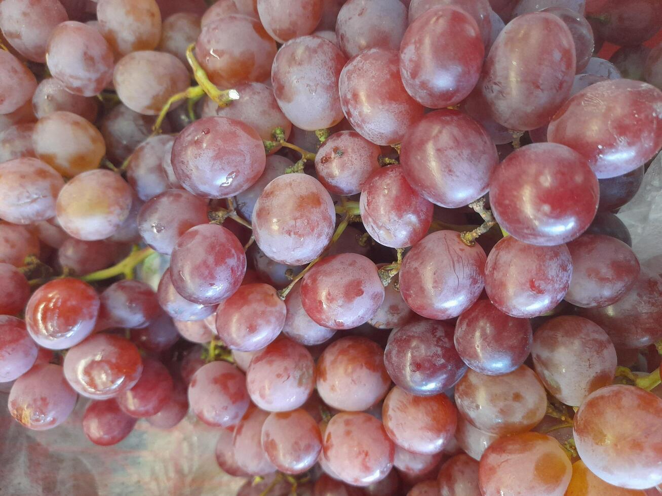 Ripe juicy sweet violet grape on the counter of the fruit store for sale photo