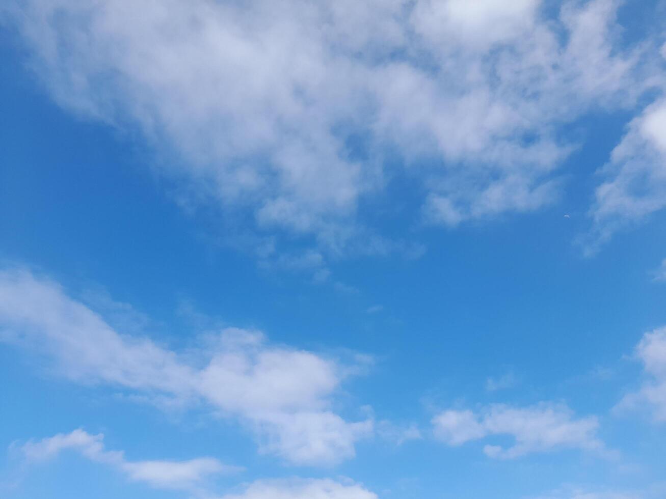 Beautiful white clouds on deep blue sky background. Large bright soft fluffy clouds are cover the entire blue sky. photo