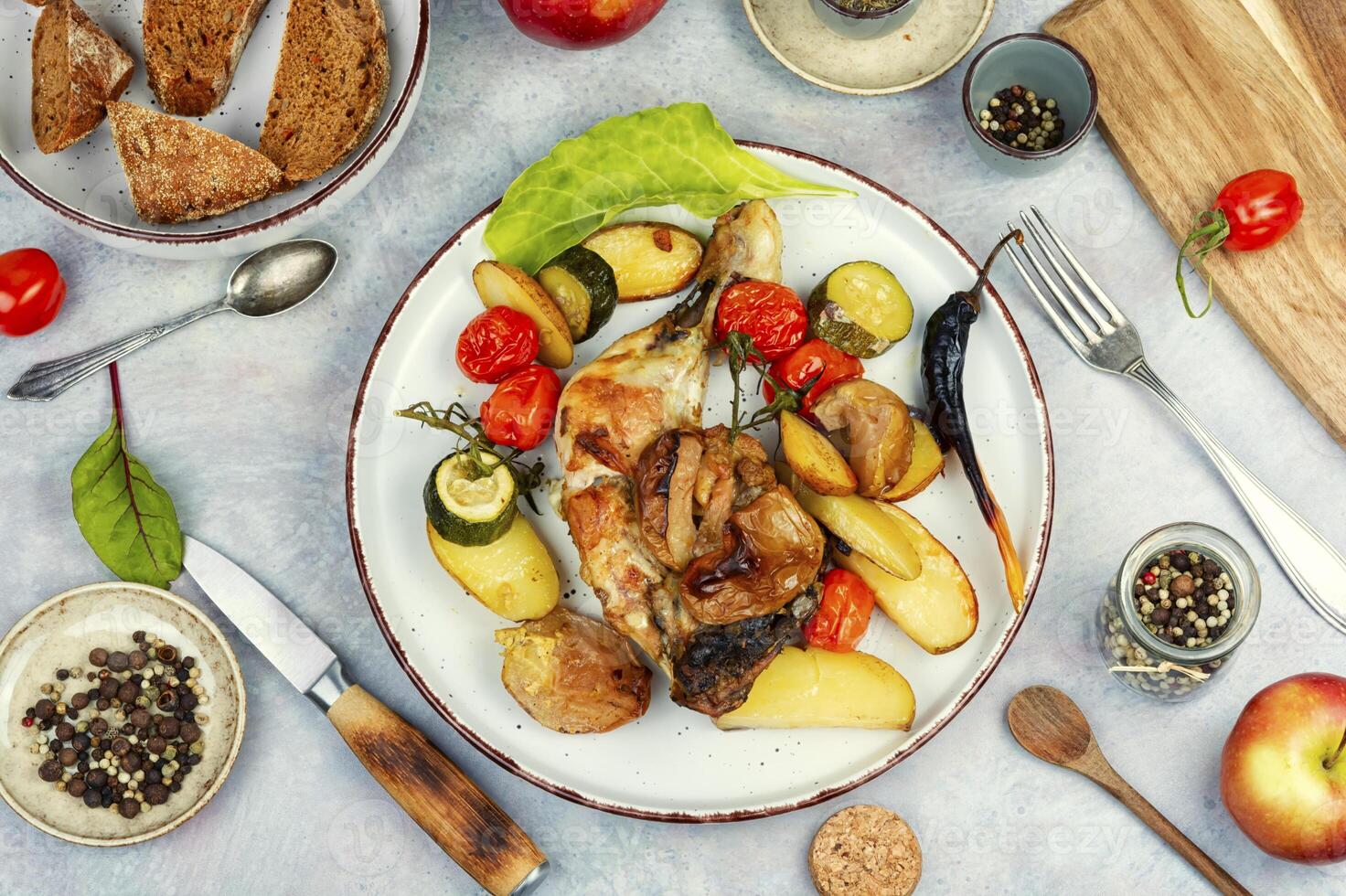 Chicken legs baked with potatoes. photo