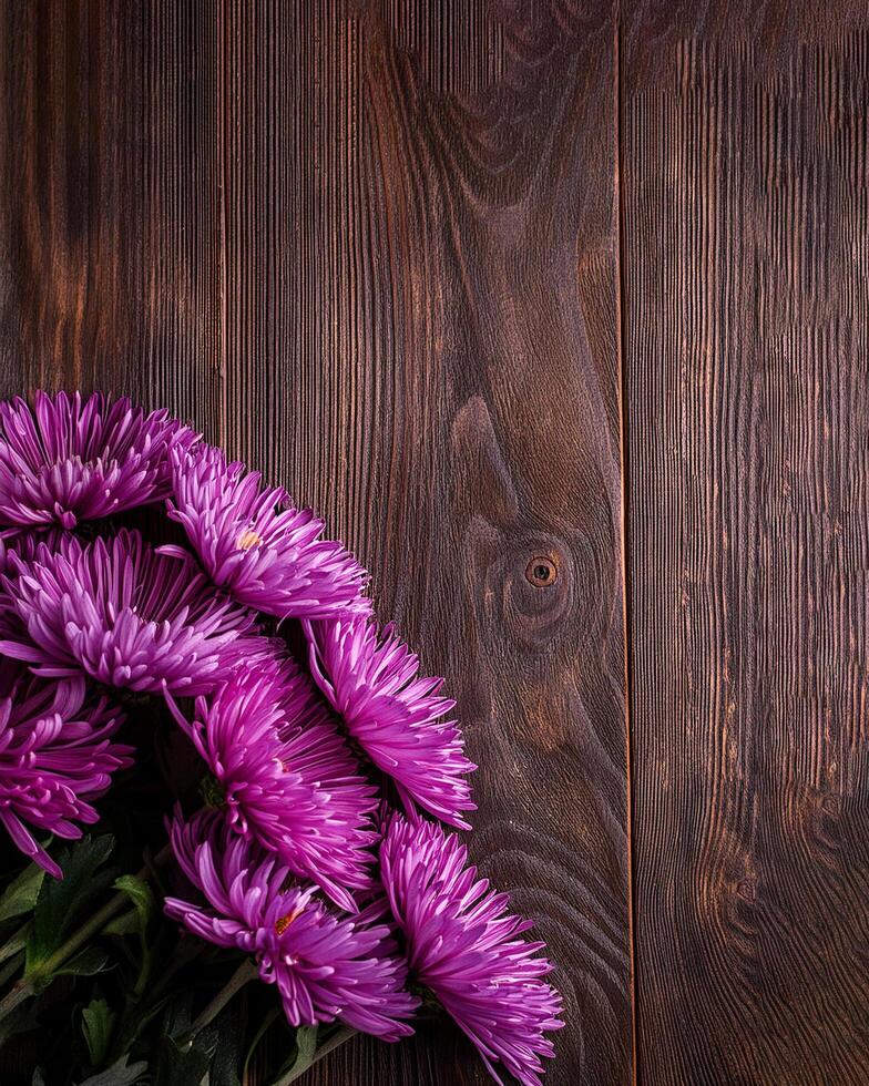 Bouquet of Purple Chrysanthemum on corner bottom right of vintage wooden table copy space, for florist or composing postcard photo