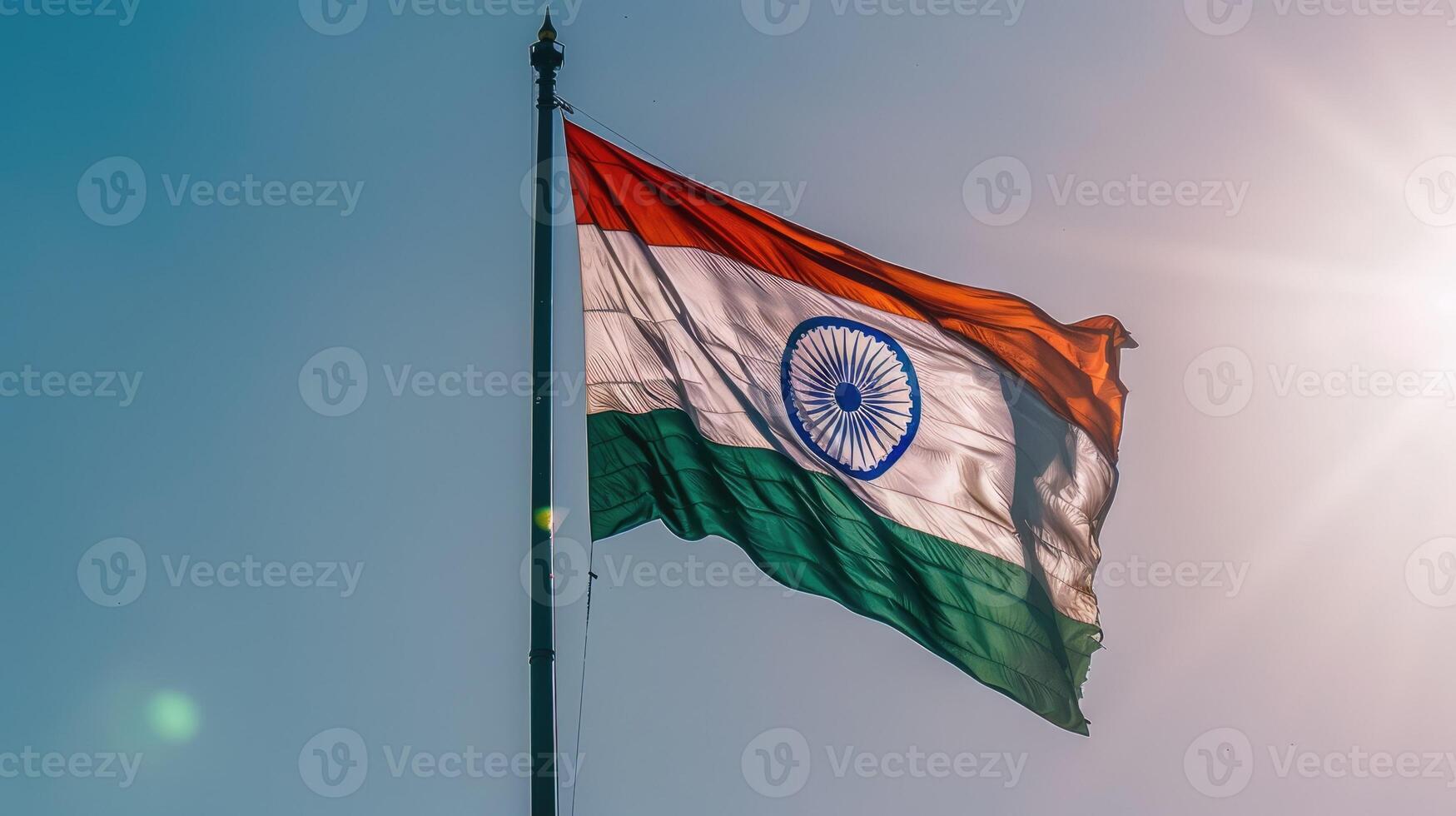 The Indian national flag proudly waves against a clear sky, symbolizing unity, patriotism, and national pride. photo