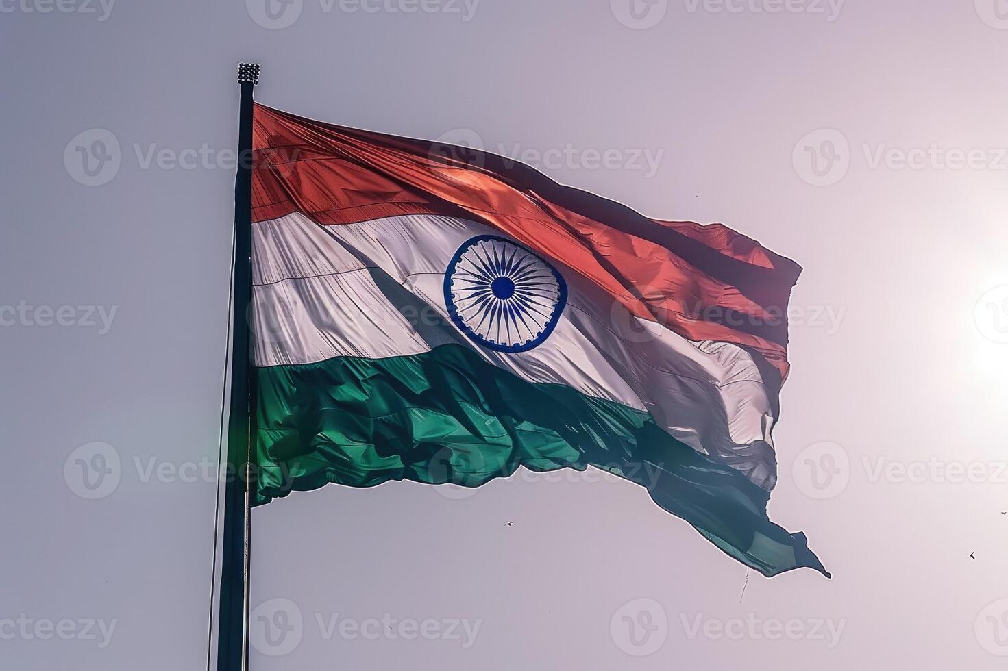 The Indian national flag proudly waves against a clear sky, symbolizing unity, patriotism, and national pride. photo