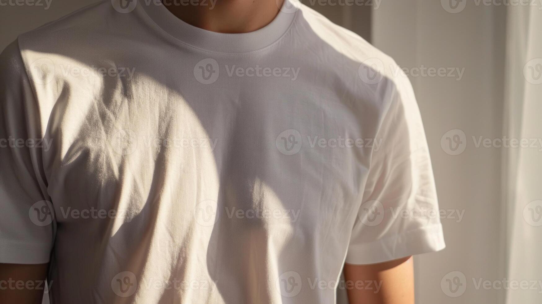 A man is wearing a white shirt and standing in front of a window photo