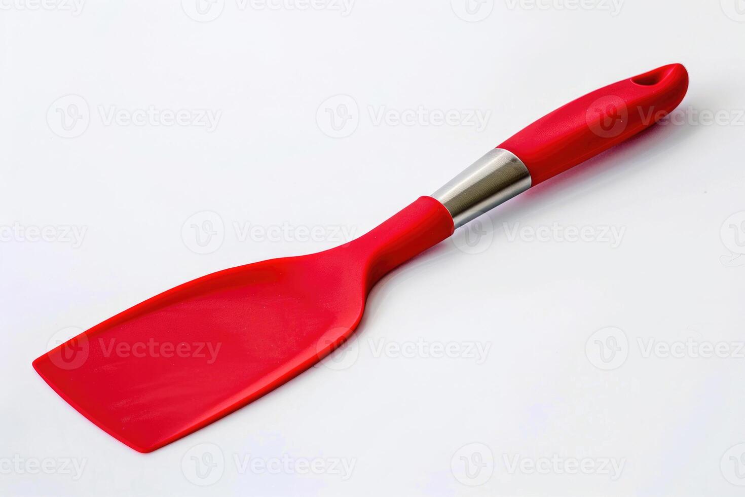 A red silicone spatula isolated on a white background. photo