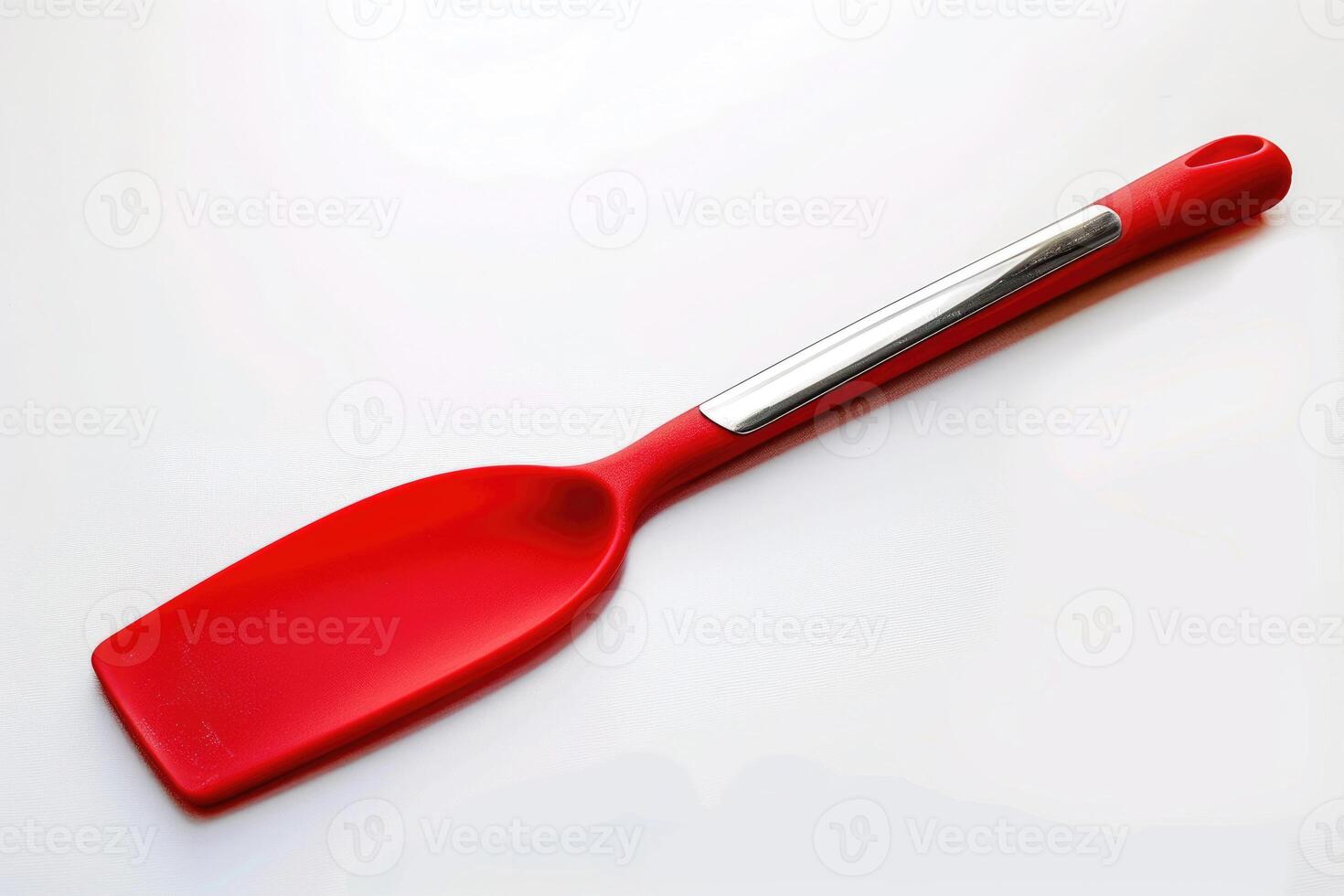 A red silicone spatula isolated on a white background. photo