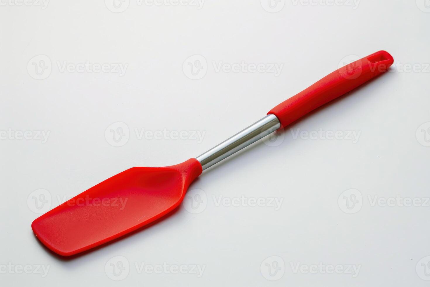 A red silicone spatula isolated on a white background. photo