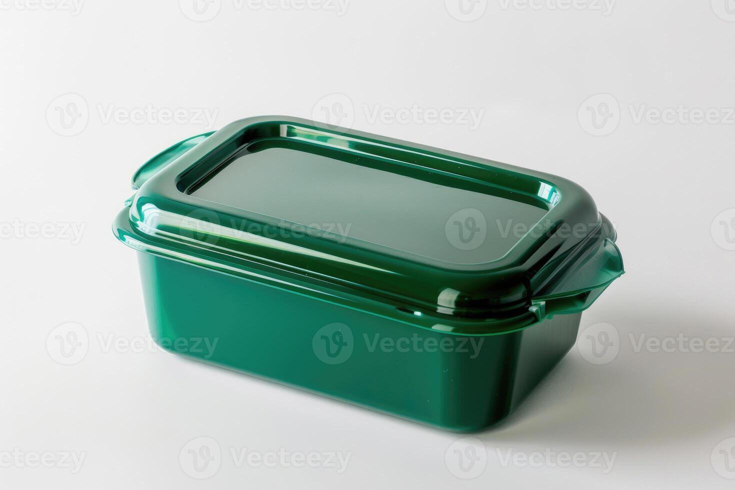 A green plastic lunch box isolated on a white background. photo