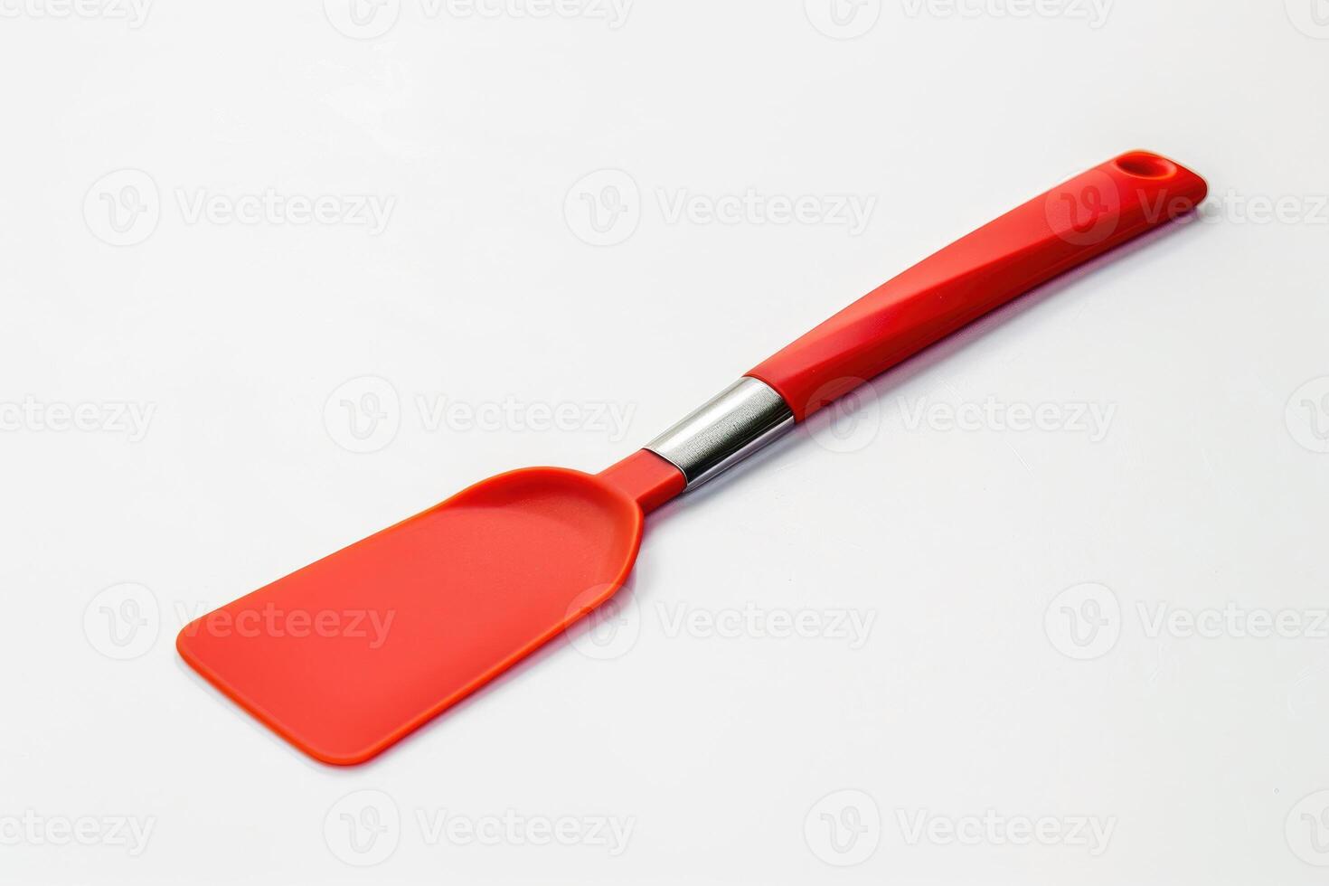 A red silicone spatula isolated on a white background. photo