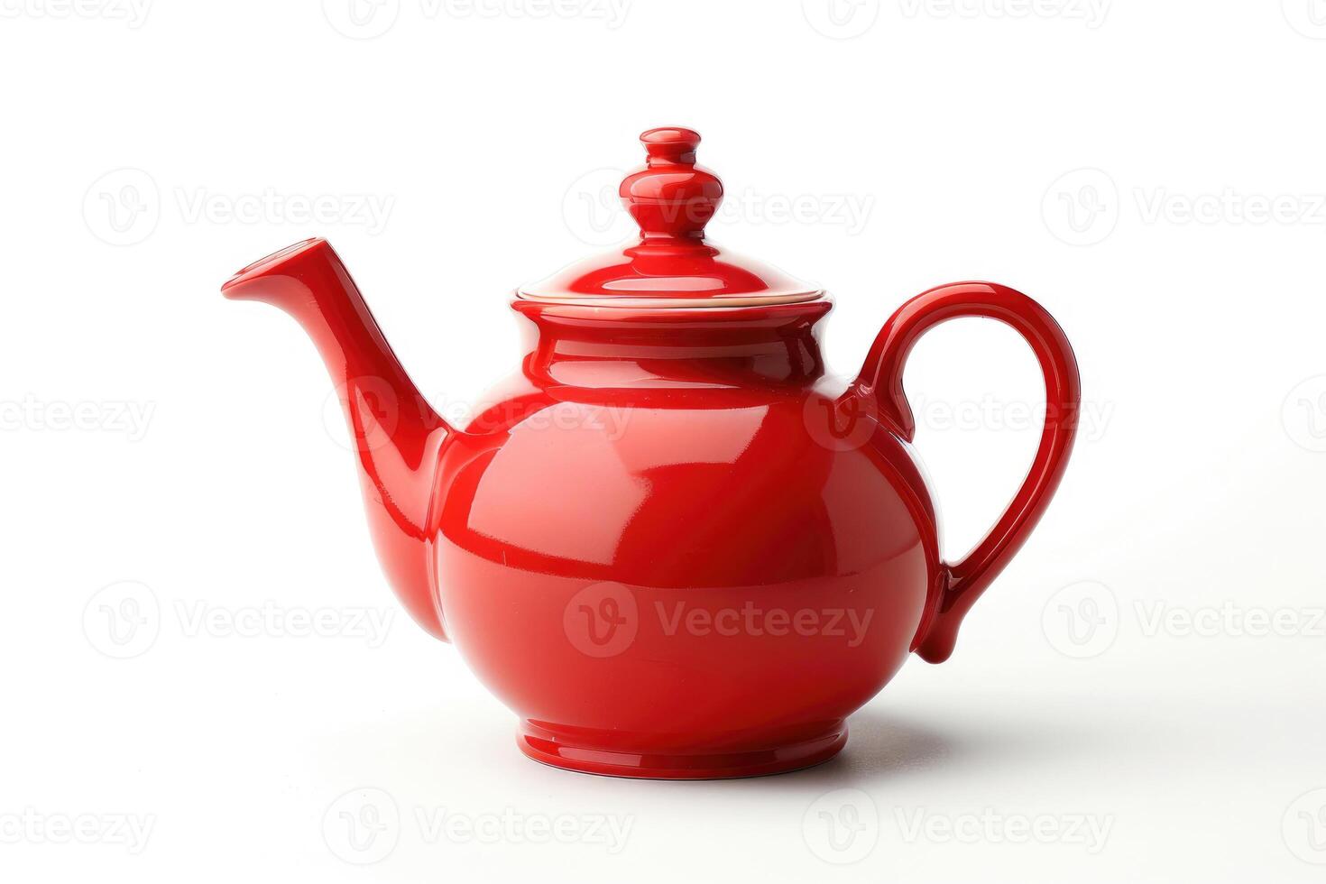 A red ceramic teapot isolated on a white background. photo