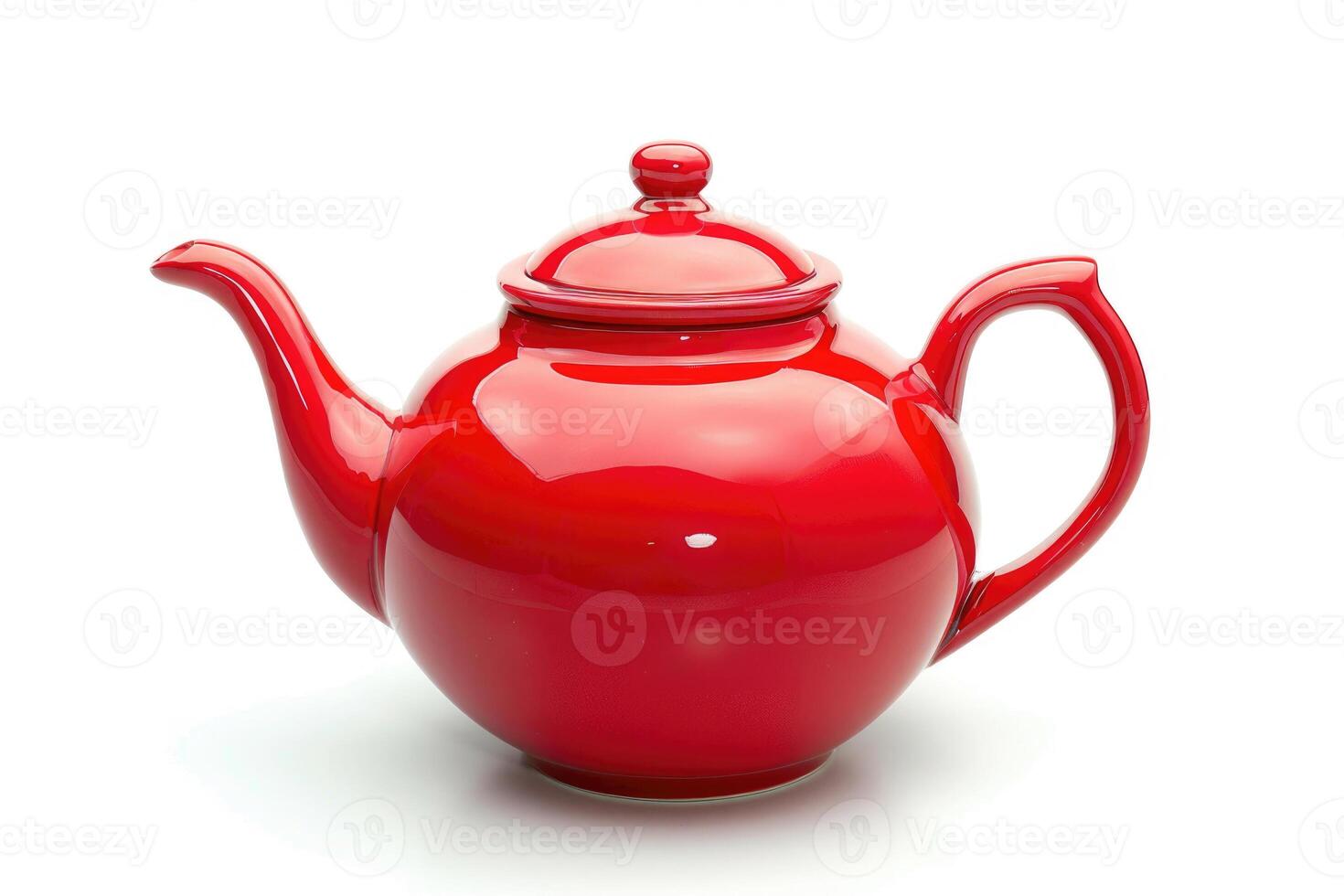 A red ceramic teapot isolated on a white background. photo