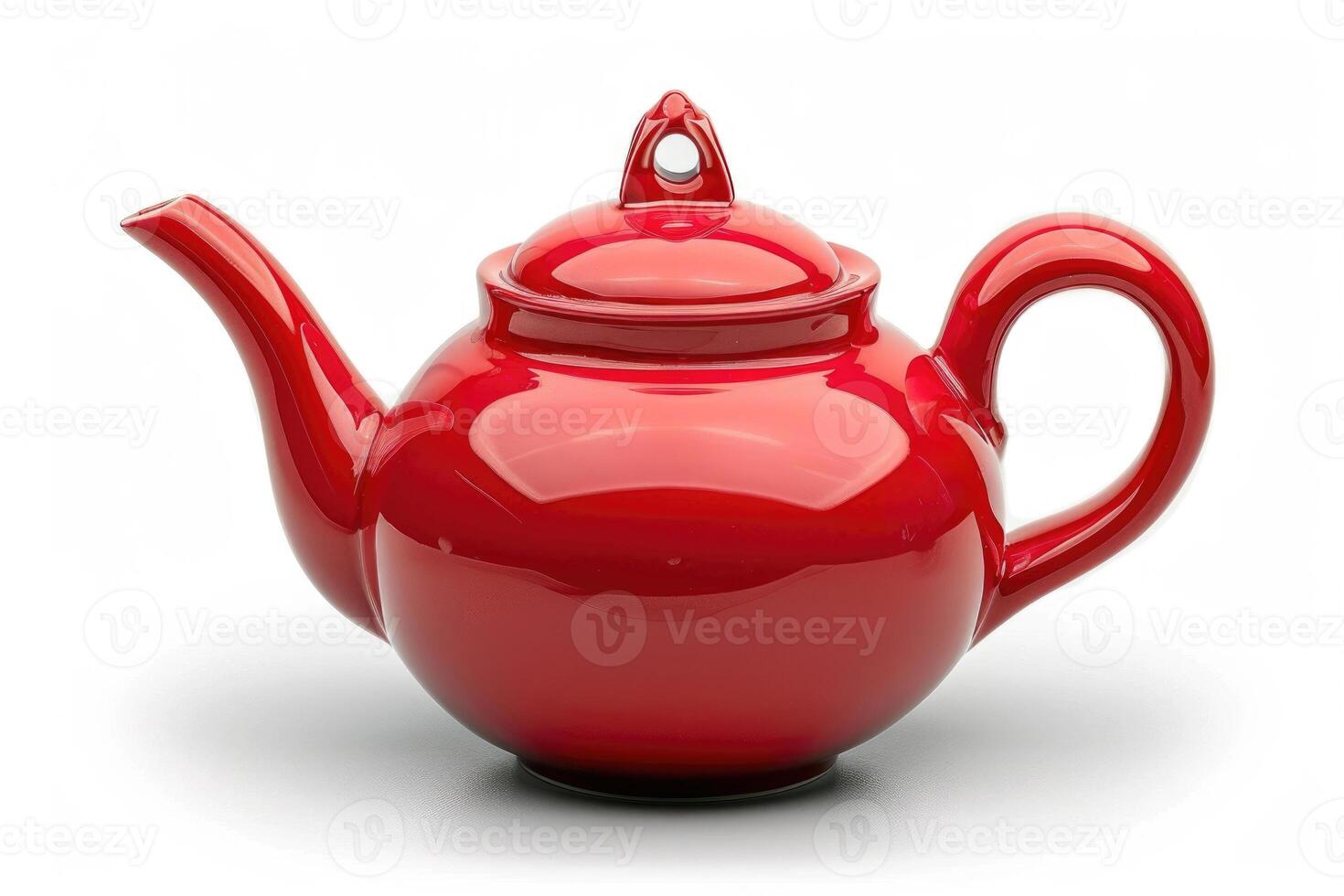 A red ceramic teapot isolated on a white background. photo