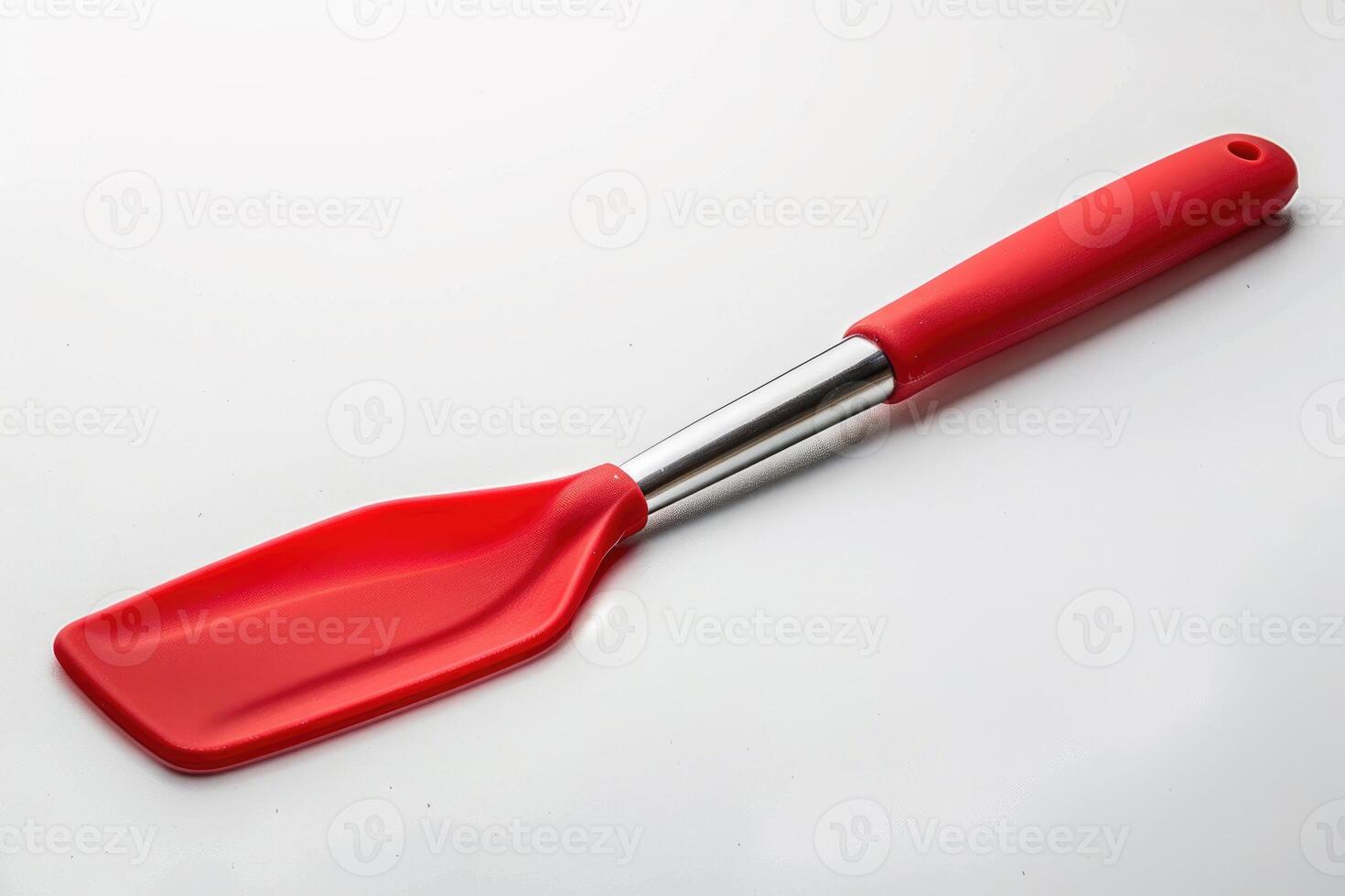 A red silicone spatula isolated on a white background. photo