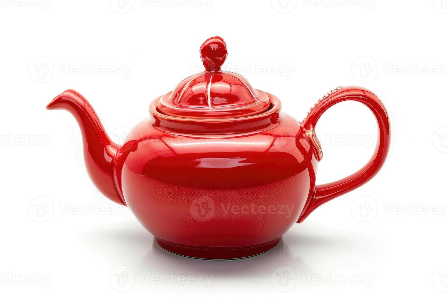 A red ceramic teapot isolated on a white background. photo