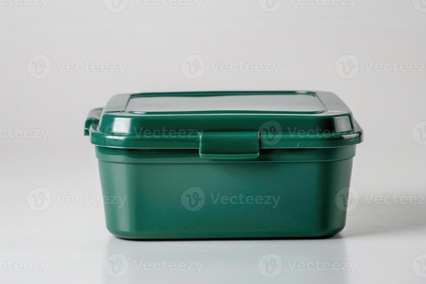 A green plastic lunch box isolated on a white background. photo