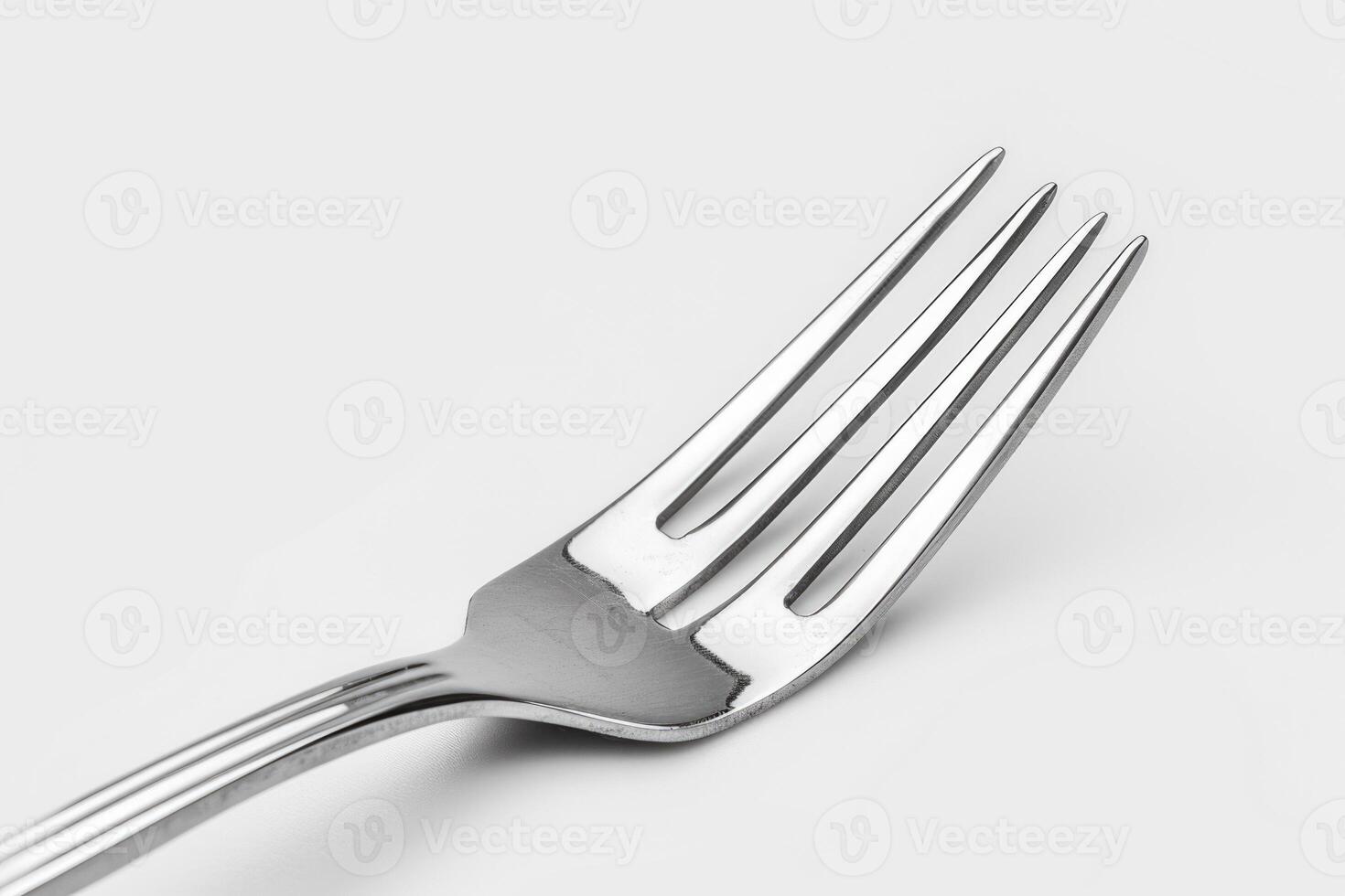 A silver stainless steel fork isolated on a white background. photo