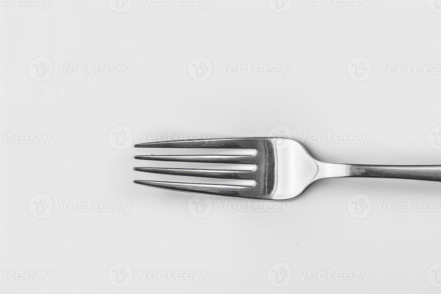 A silver stainless steel fork isolated on a white background. photo