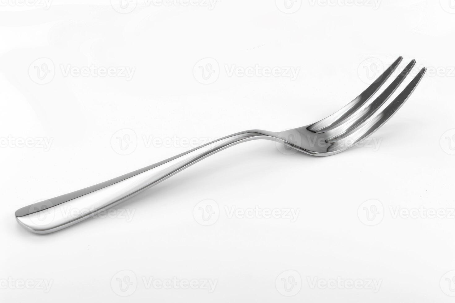 A silver stainless steel fork isolated on a white background. photo