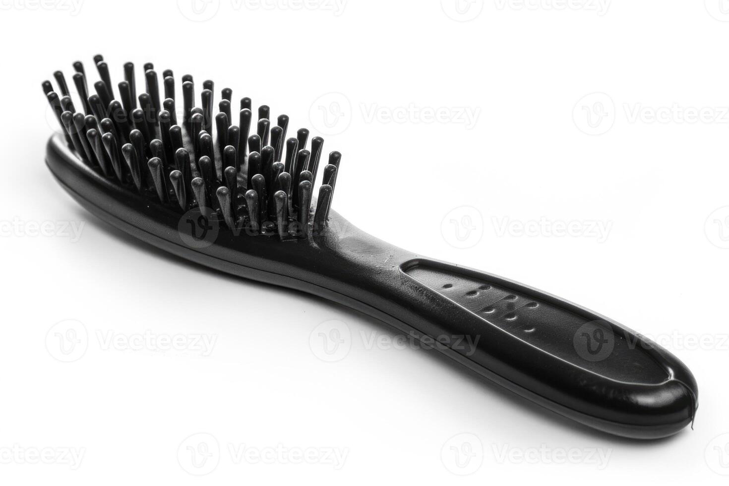 A black plastic hairbrush isolated on a white background. photo