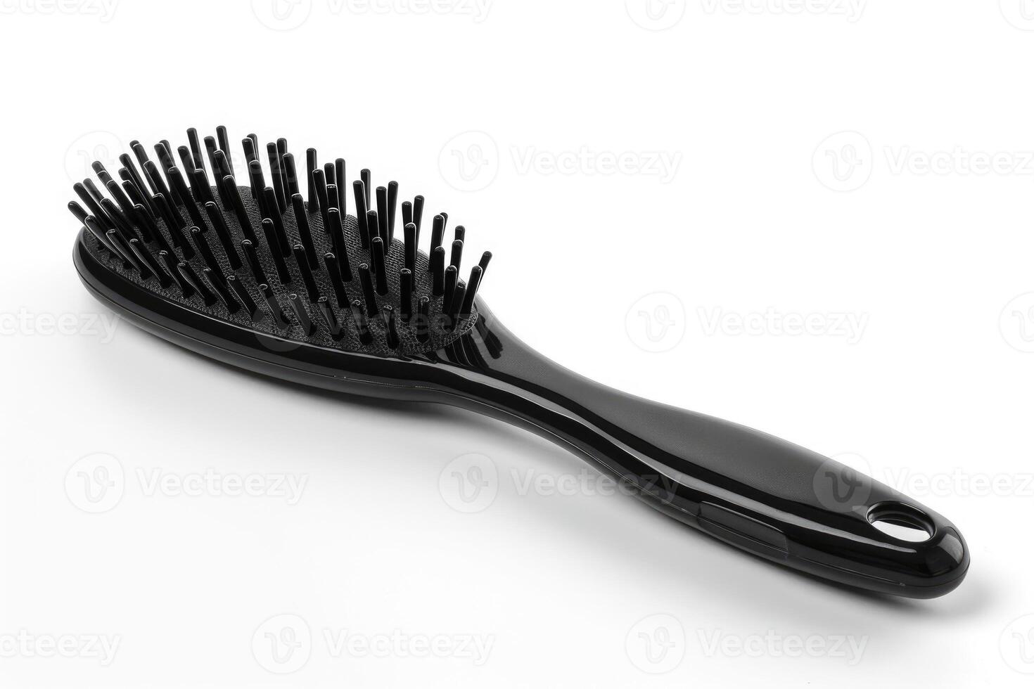 A black plastic hairbrush isolated on a white background. photo