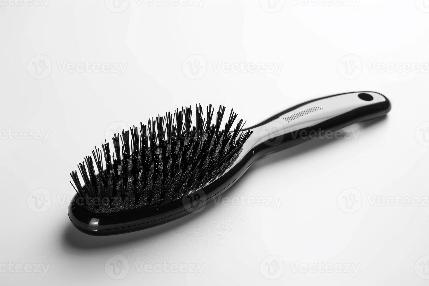 A black plastic hairbrush isolated on a white background. photo