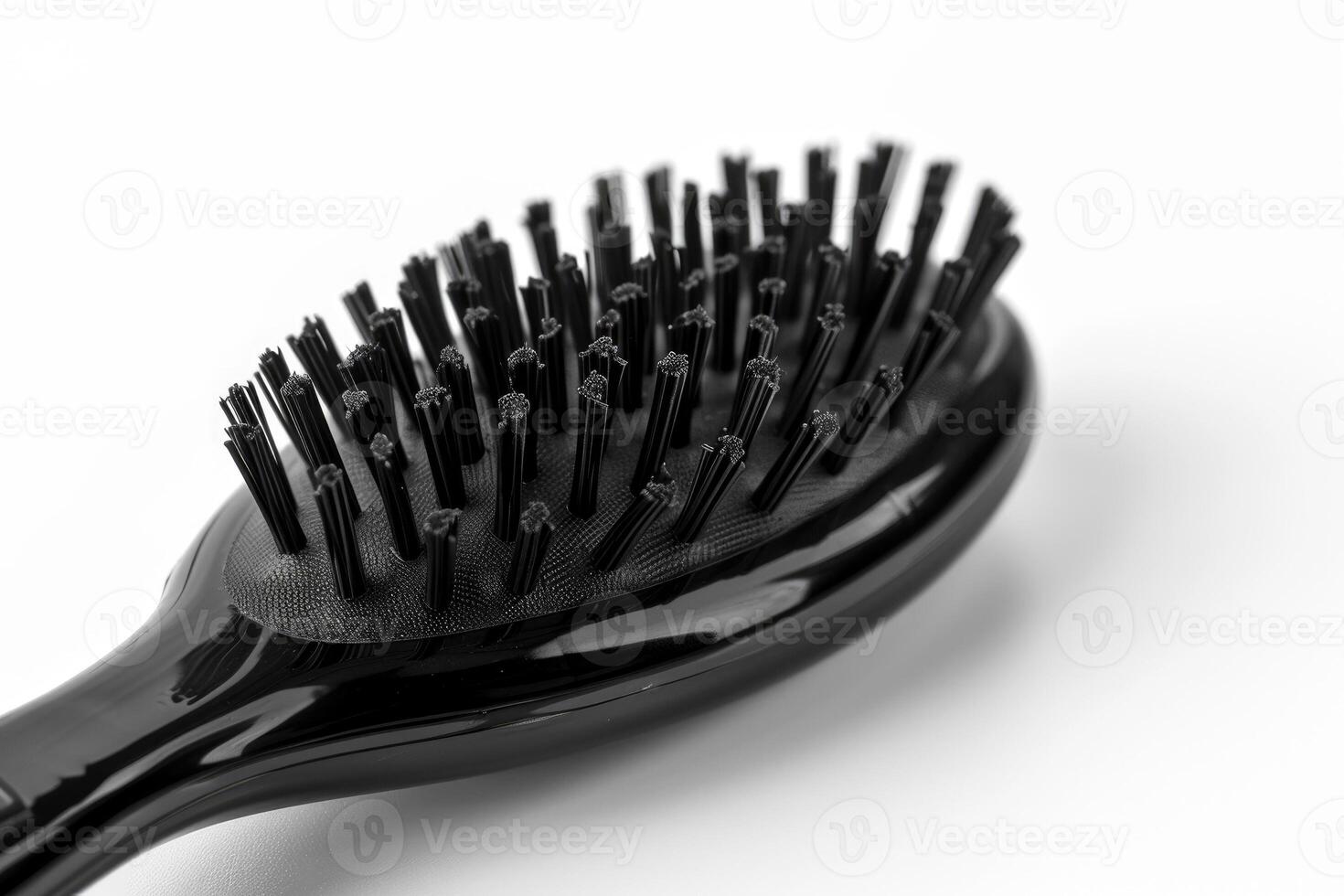 A black plastic hairbrush isolated on a white background. photo