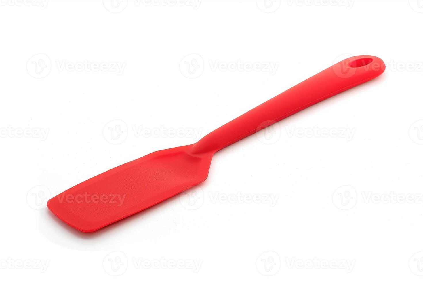 Red silicone spatula on a white background. photo