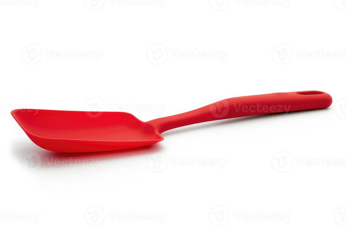 Red silicone spatula on a white background. photo