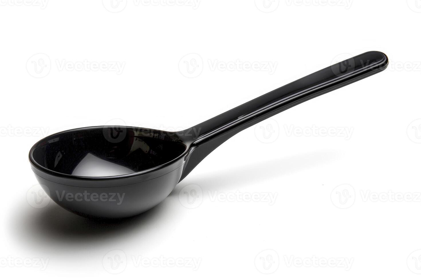 Black plastic soup ladle on a white background. photo