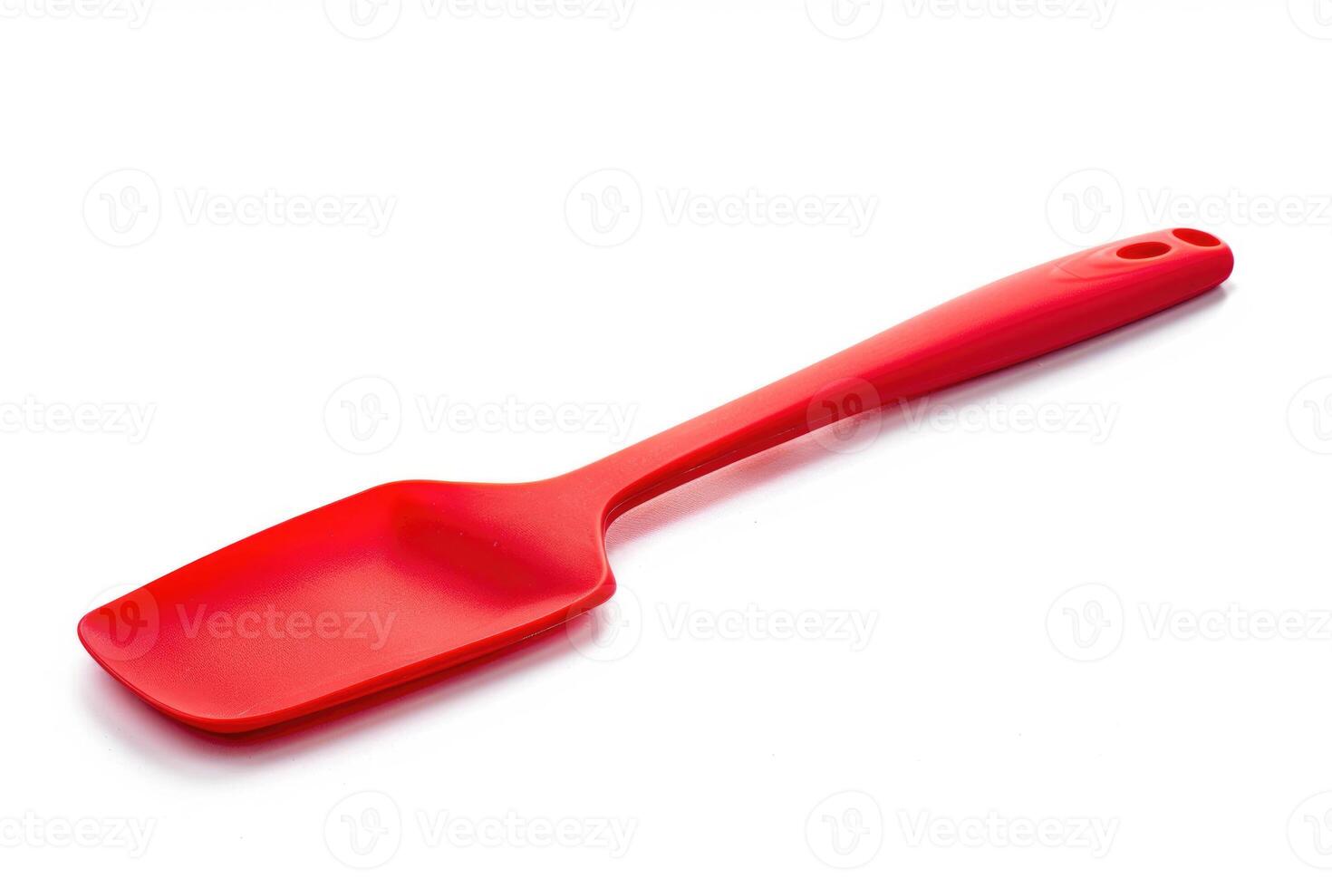 Red silicone spatula on a white background. photo