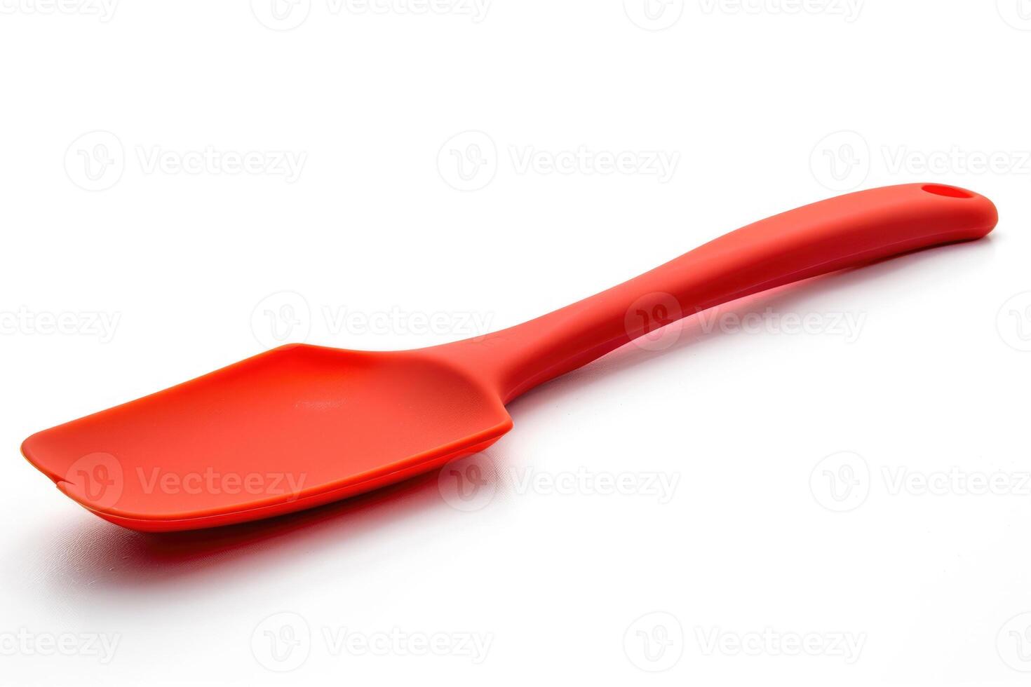 Red silicone spatula on a white background. photo