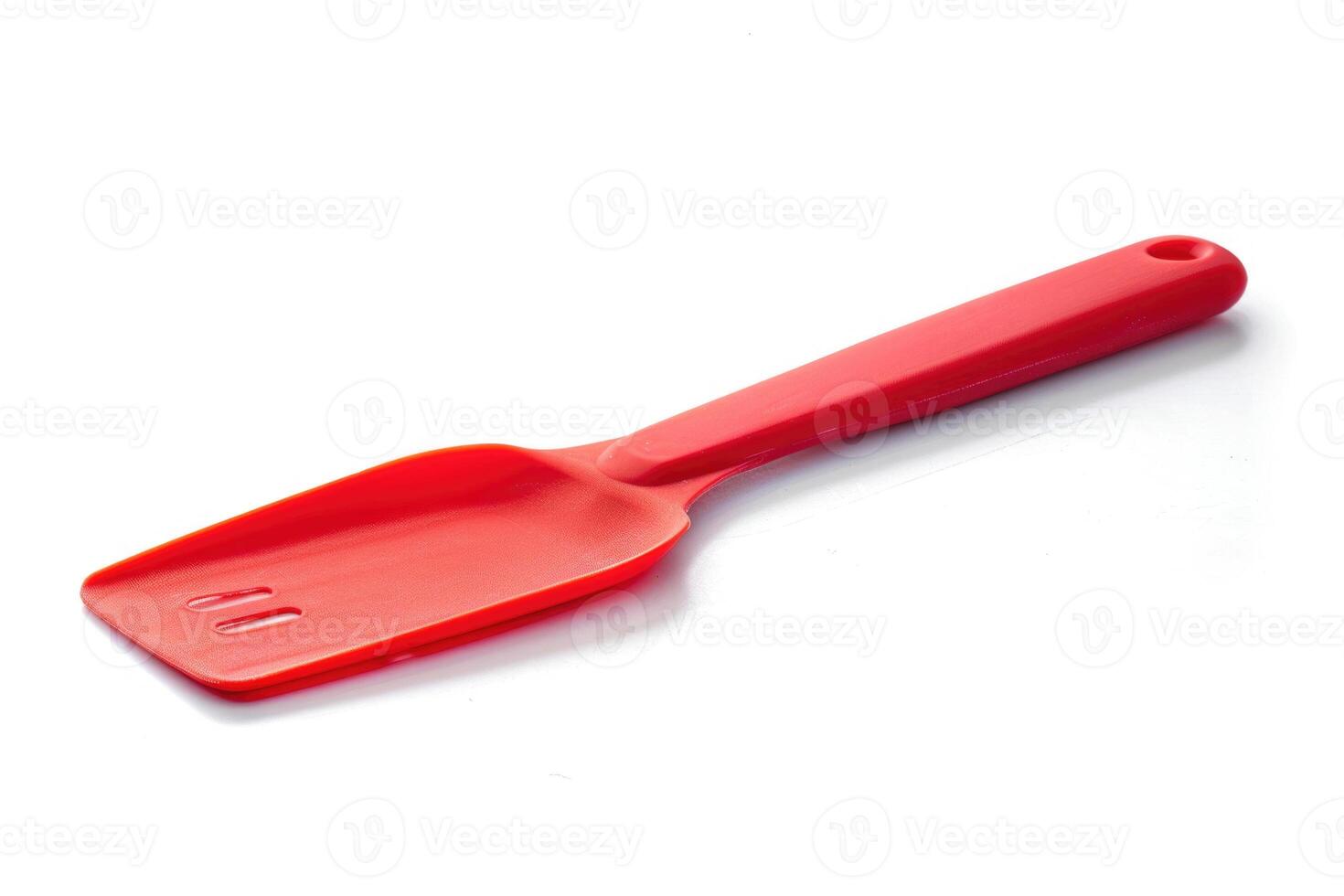 Red silicone spatula on a white background. photo