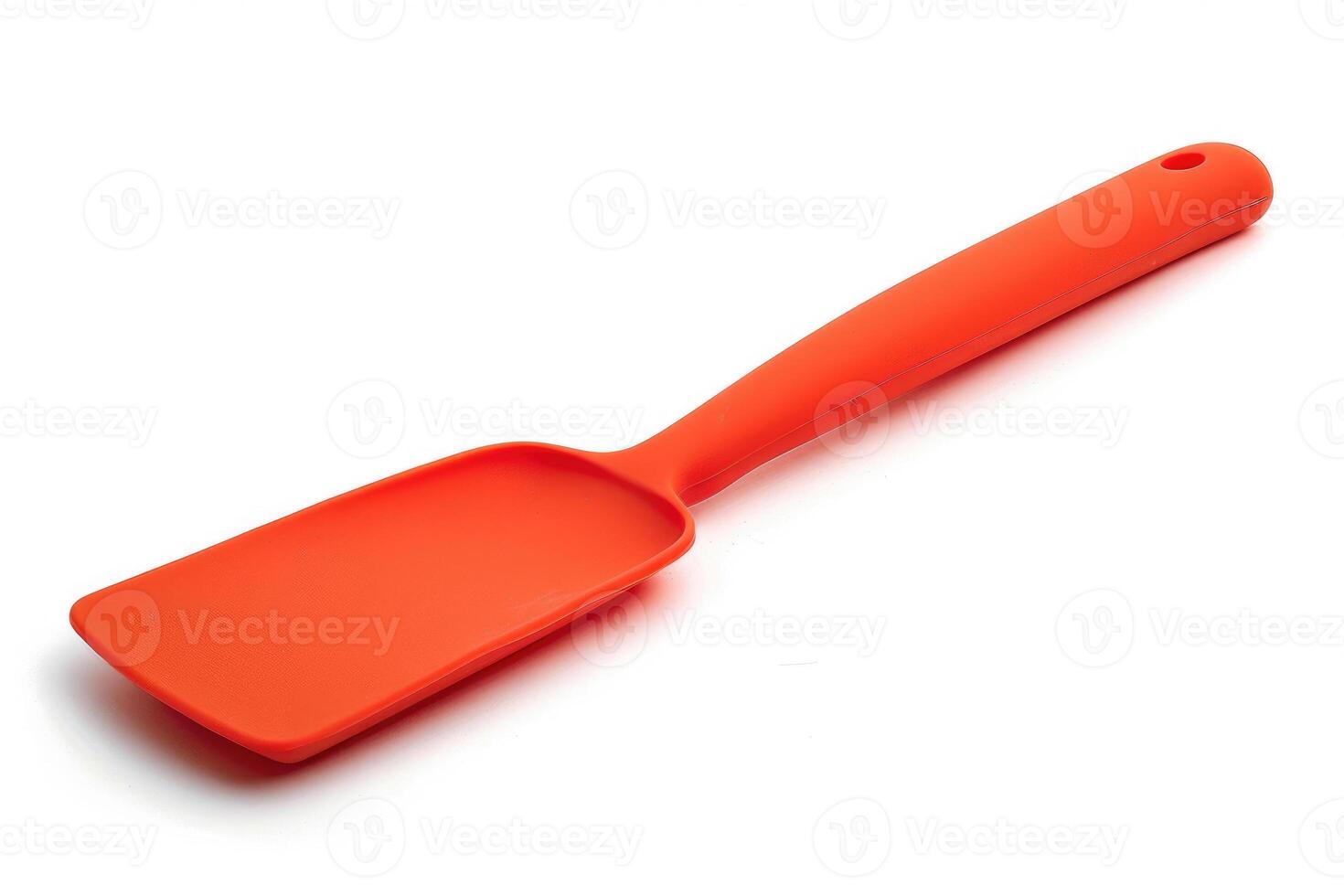 Red silicone spatula on a white background. photo