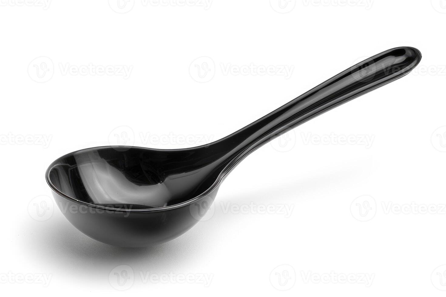 Black plastic soup ladle on a white background. photo