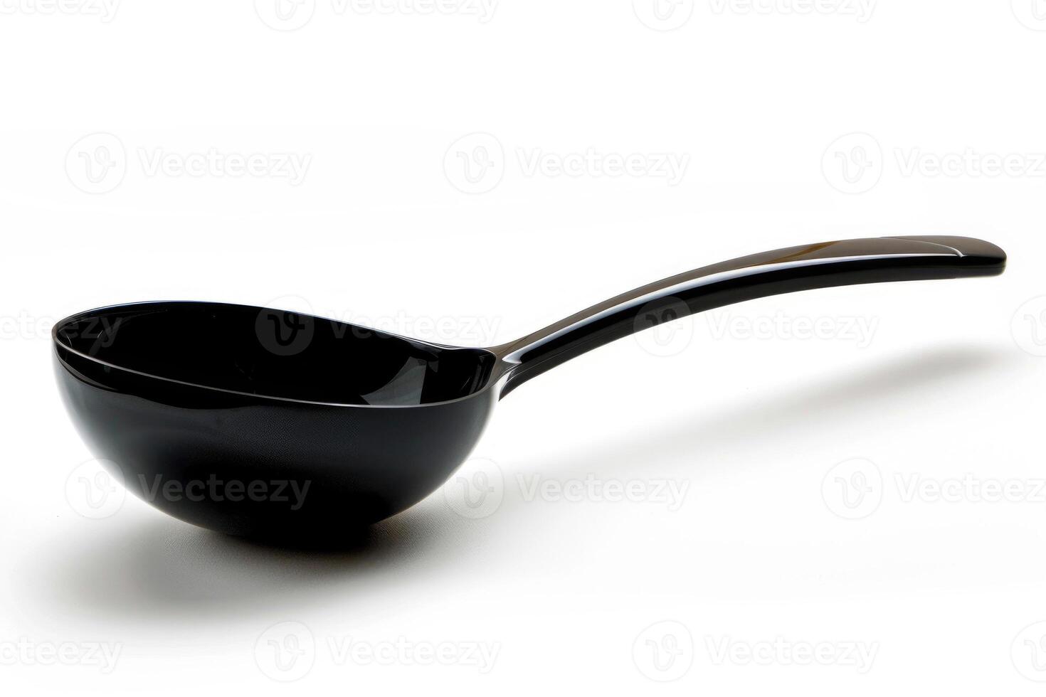 Black plastic soup ladle on a white background. photo