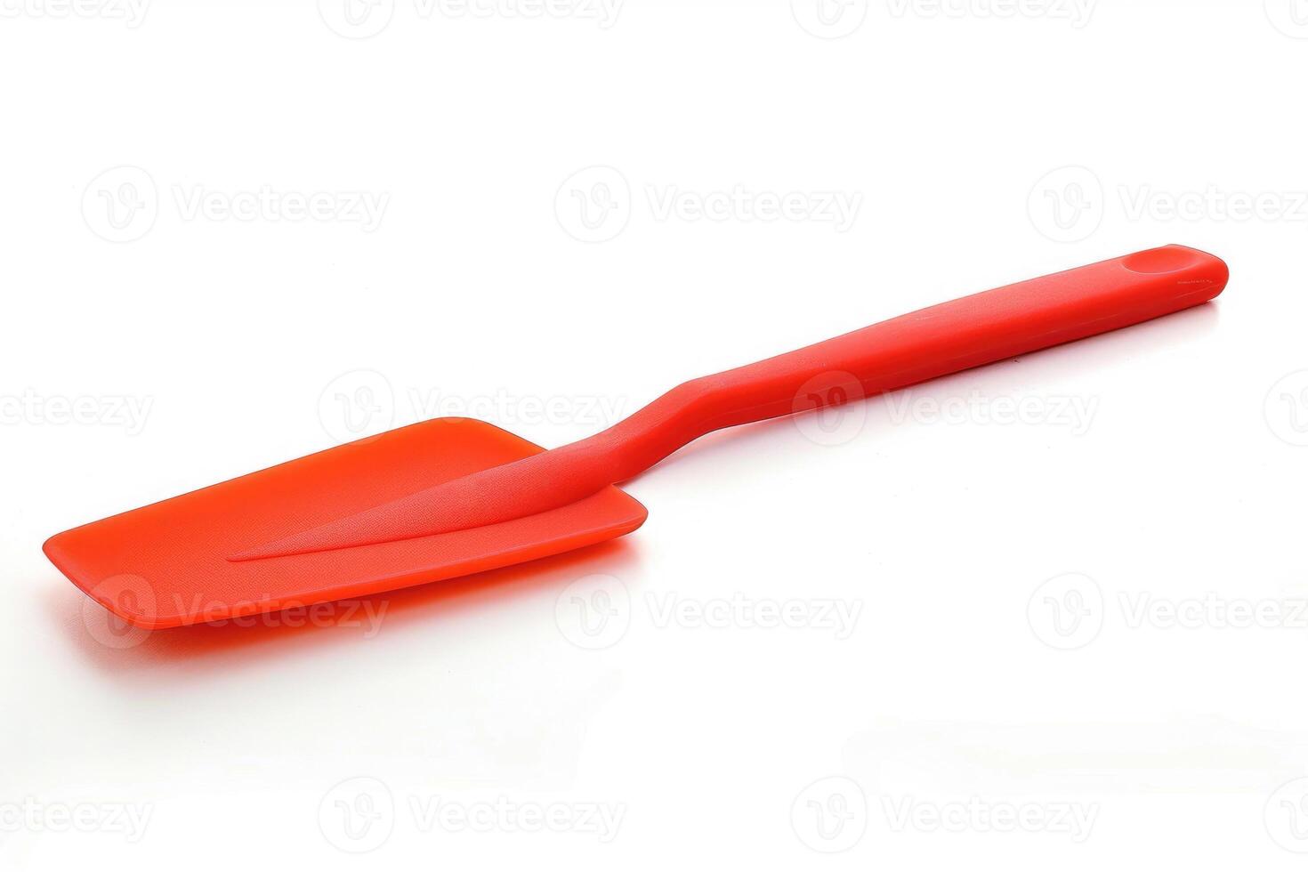 Red silicone spatula on a white background. photo
