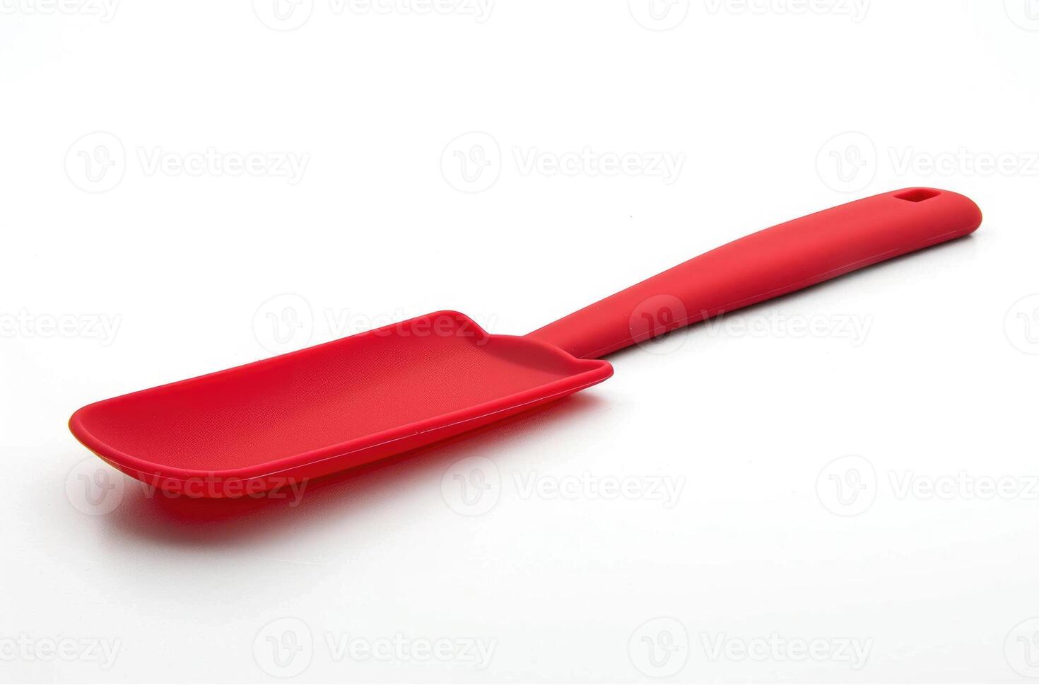 Red silicone spatula on a white background. photo