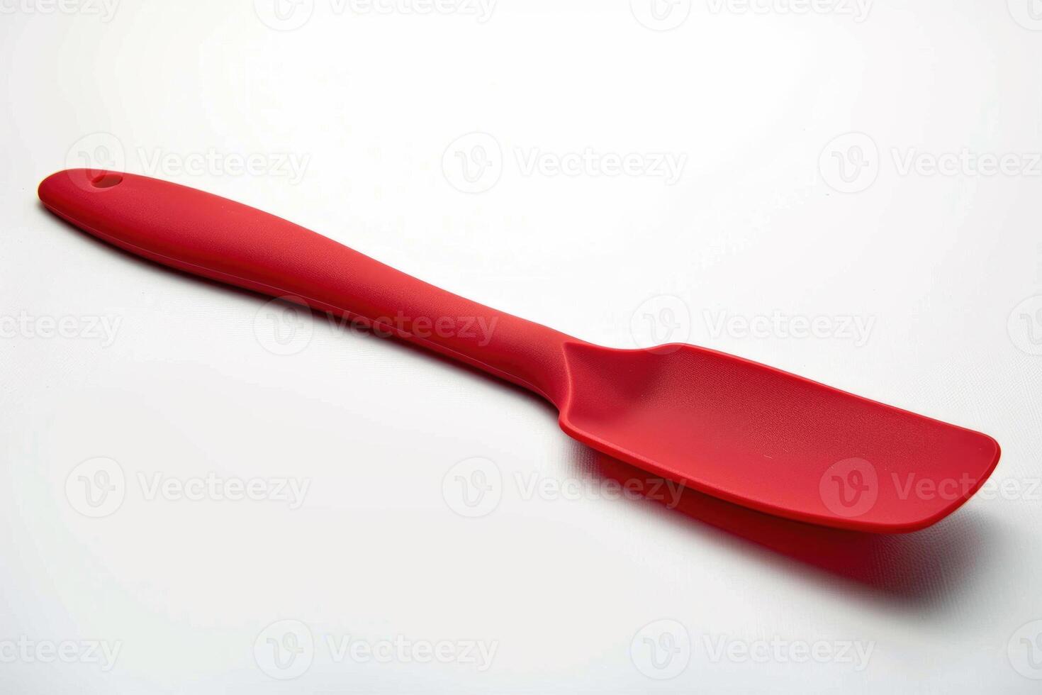 Red silicone spatula on a white background. photo