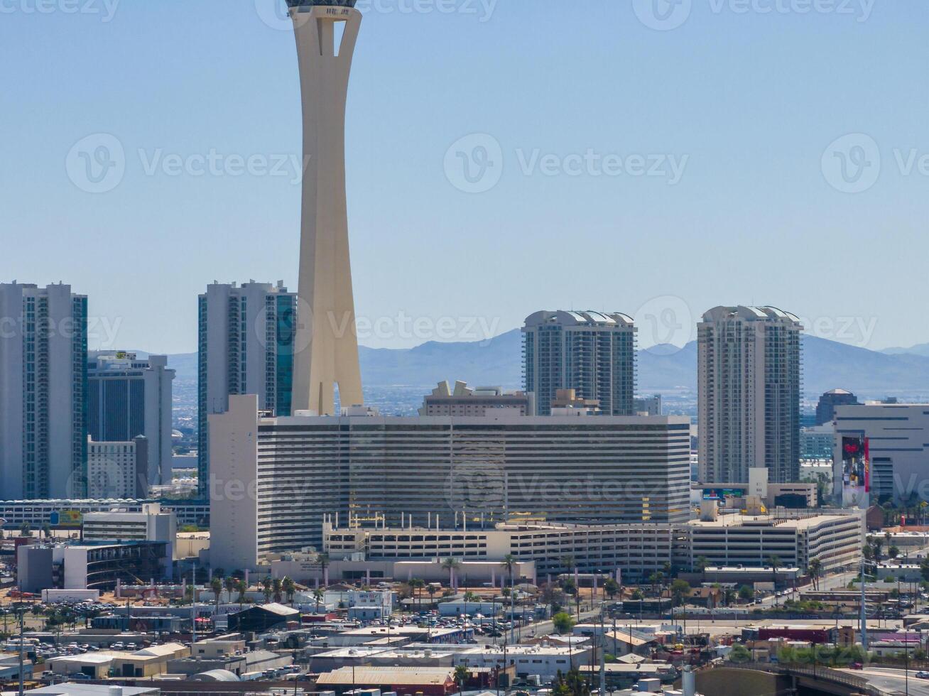 Aerial View of Las Vegas Skyline Featuring Stratosphere Tower Amidst High-Rises and Mountains photo