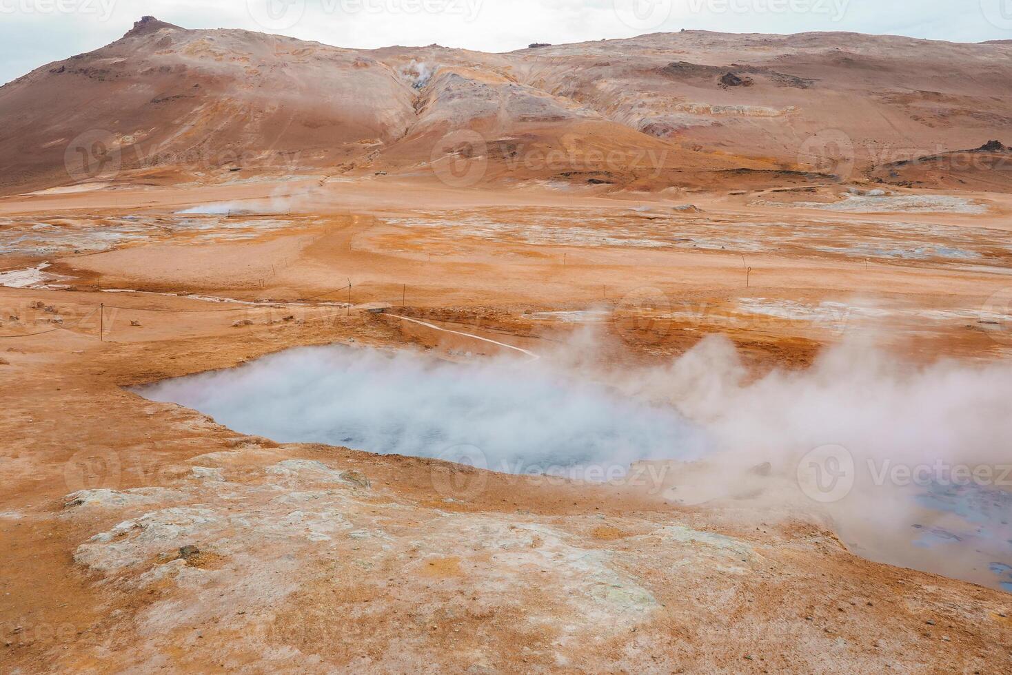 Steaming Hot Springs and Rocky Terrain in Iceland's Geothermal Area photo