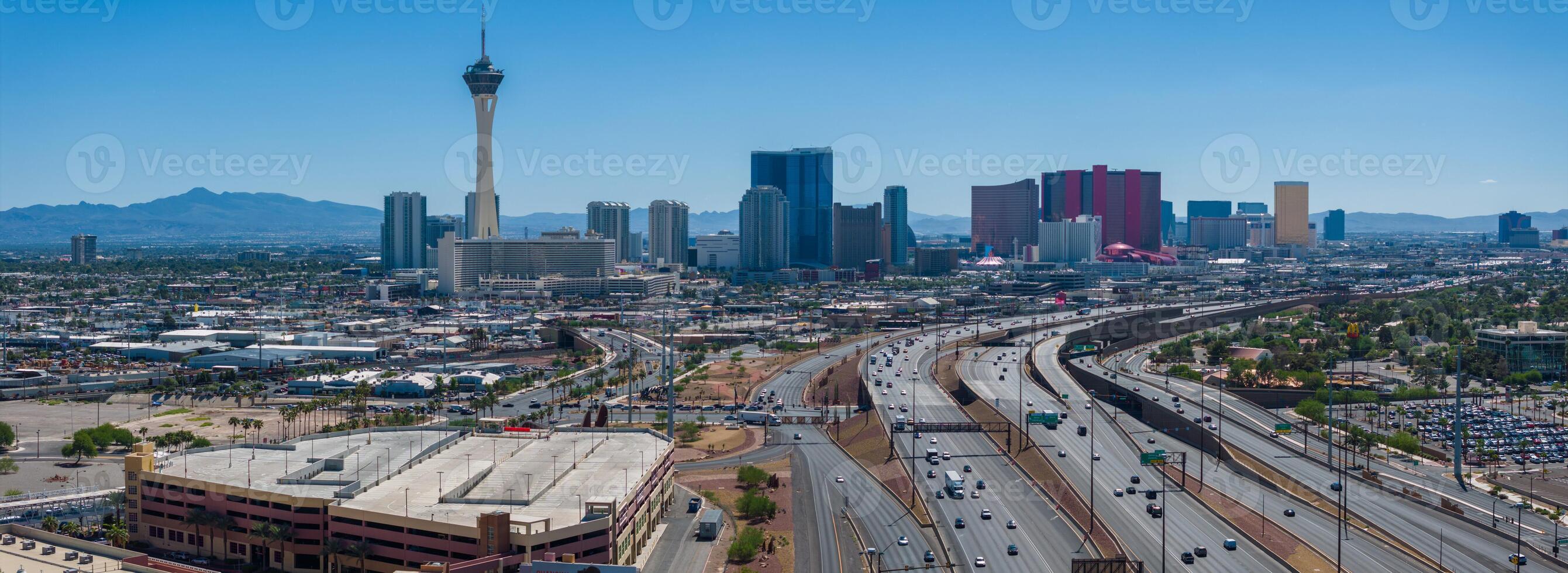 Sunny Las Vegas Cityscape with Stratosphere Tower and Mountains, Aerial View of Urban Skyline photo