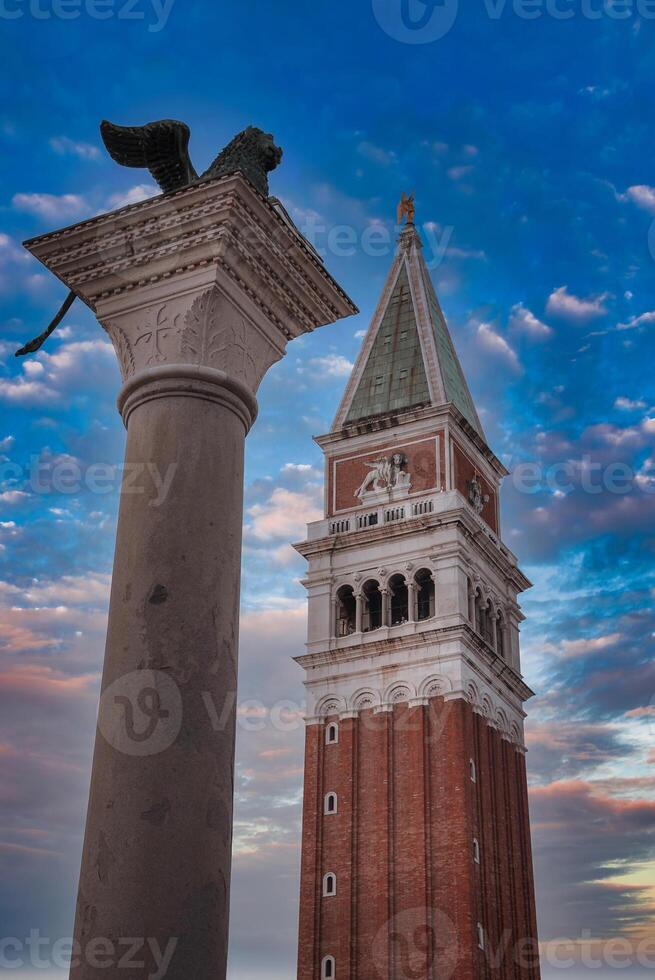 Daytime view of lion statue and clock tower in Piazza San Marco, Venice, Italy photo