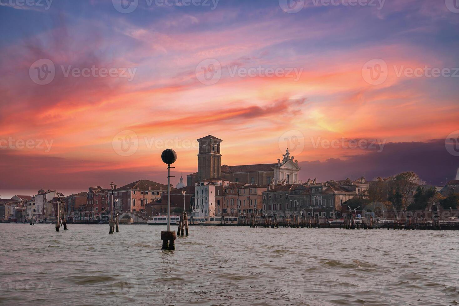 Tranquil Venetian Gondola Floating on Clear Water with Cityscape in the Background photo