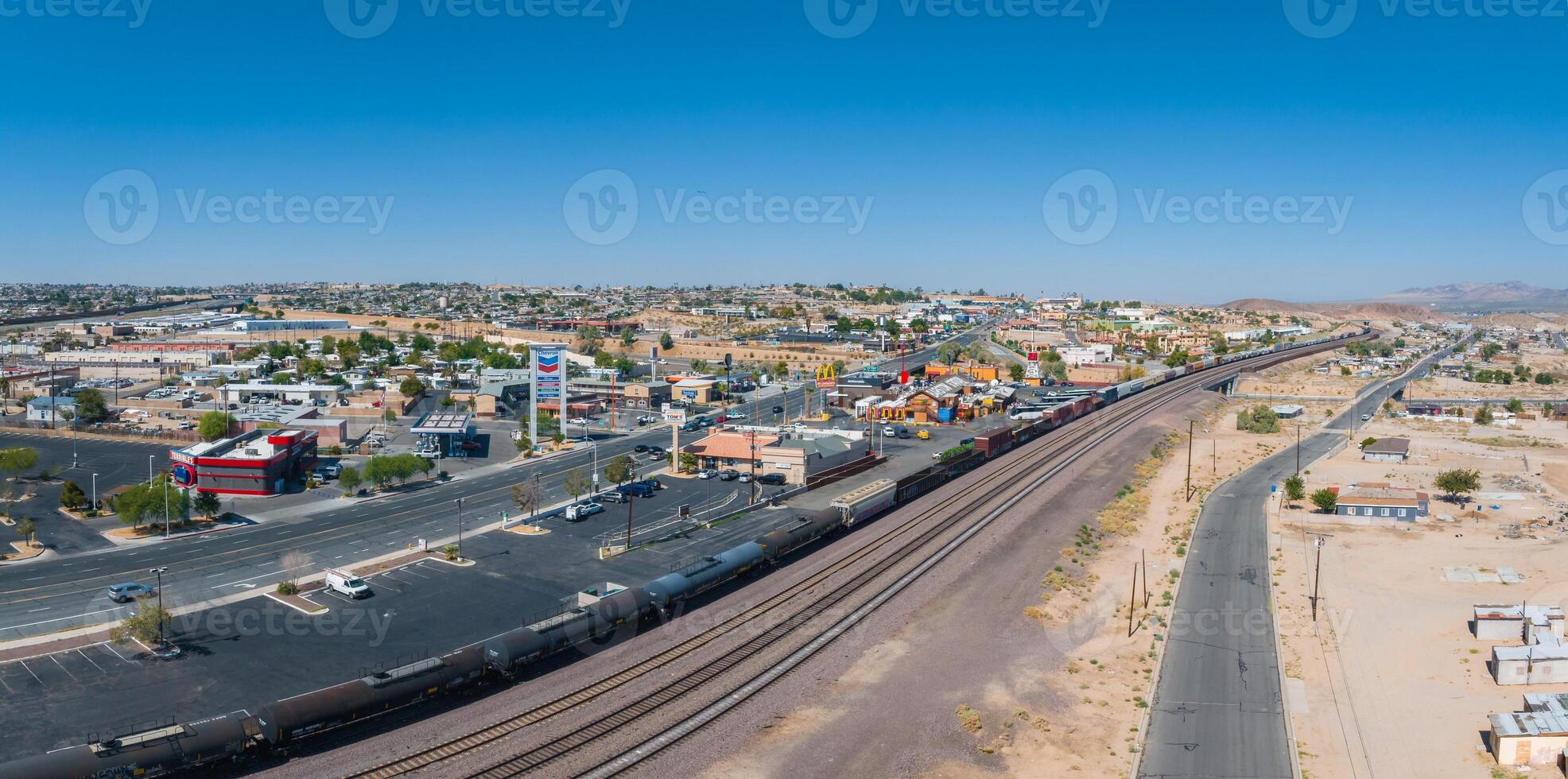 Aerial View of Barstow Suburb on Route 66 with Railway Tracks in Sunny Southwestern Landscape photo