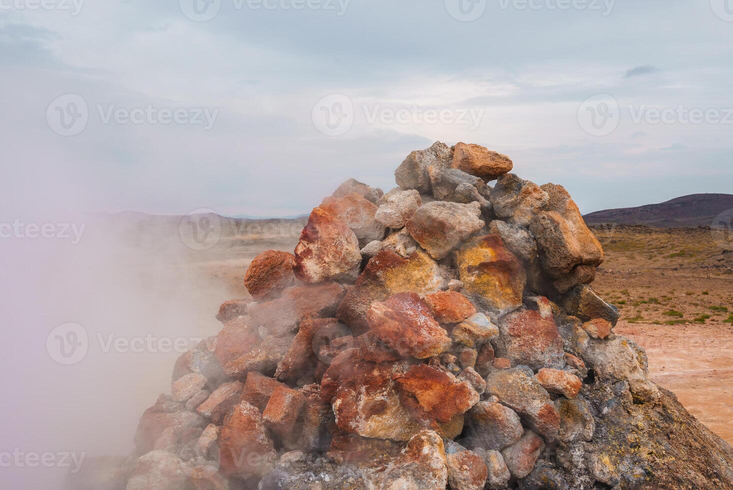 Steaming Fumarole in Geothermal Area with Rocky Landscape in Iceland photo