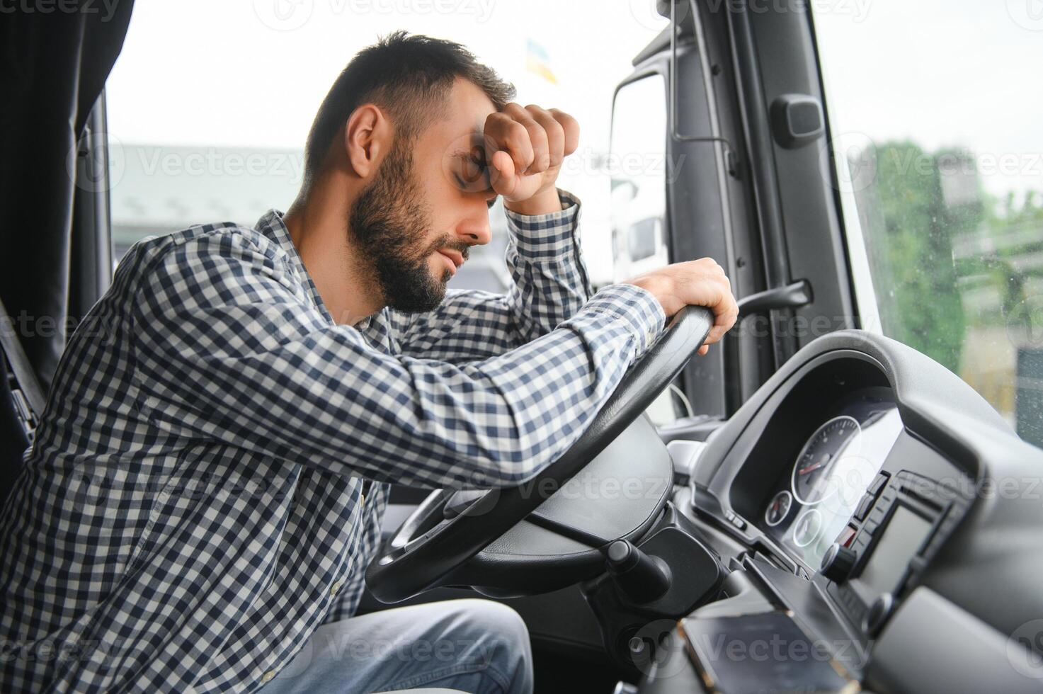 Portrait of tired truck driver feeling sleepy and sick. photo