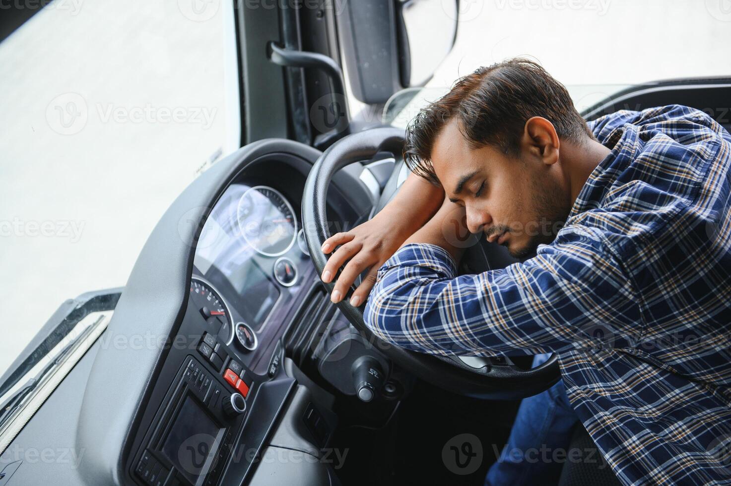 Portrait of tired indian truck driver feeling sleepy and sick. photo