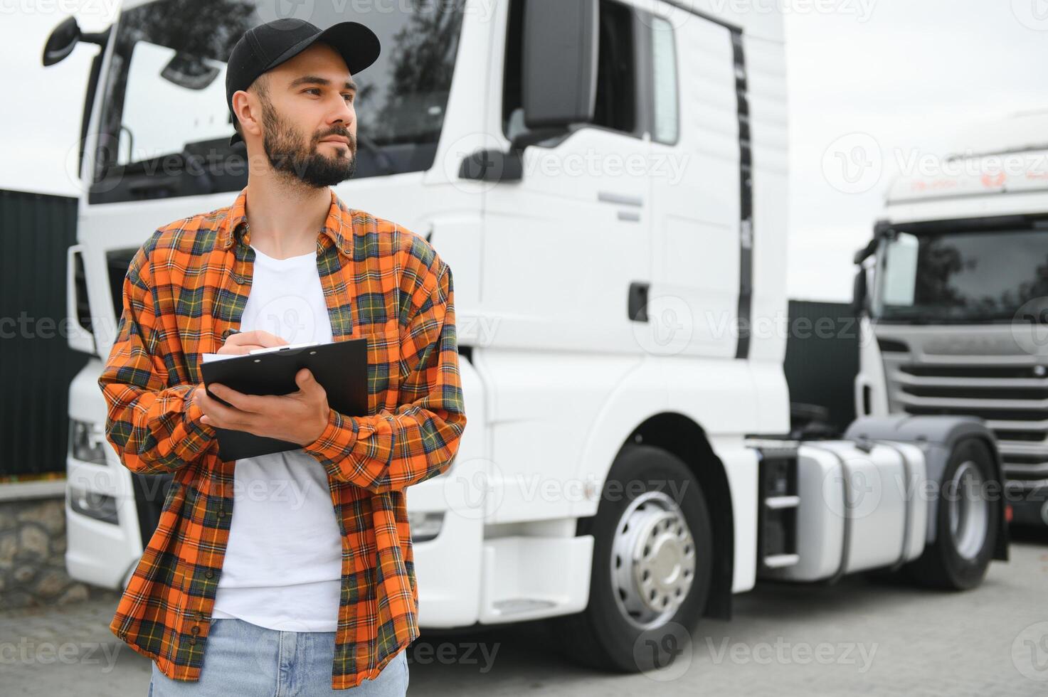 Portrait of confident truck driver on parking lot. Copy space photo
