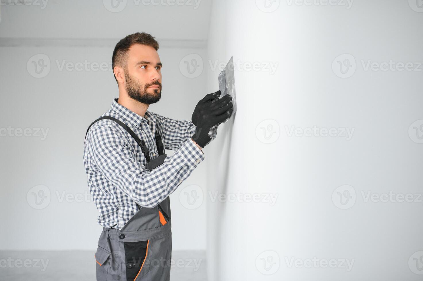 Young worker making repair in room. photo