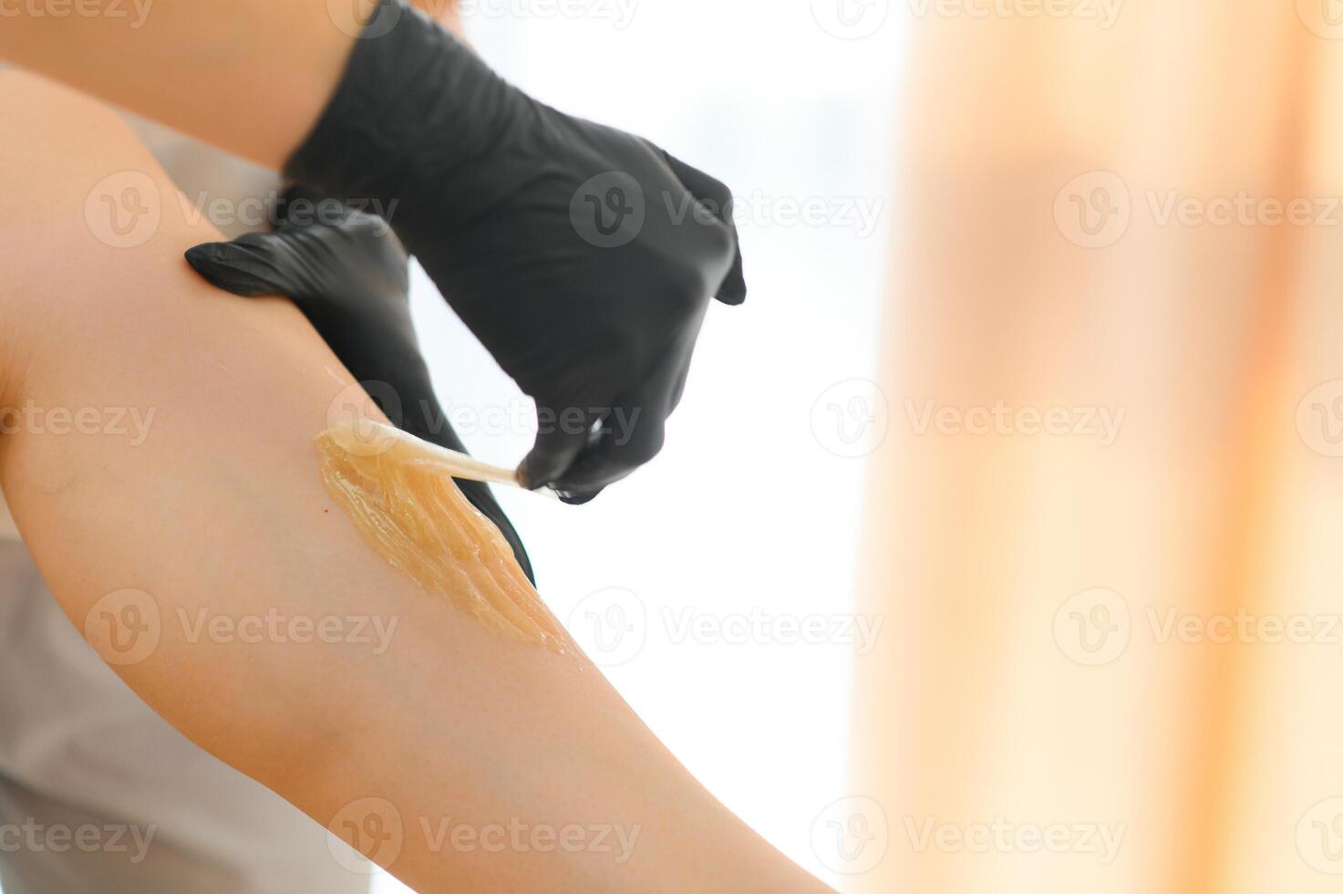 Sugaring epilation skin care with liquid sugar at legs close-up. Beauty and cosmetology concept. photo
