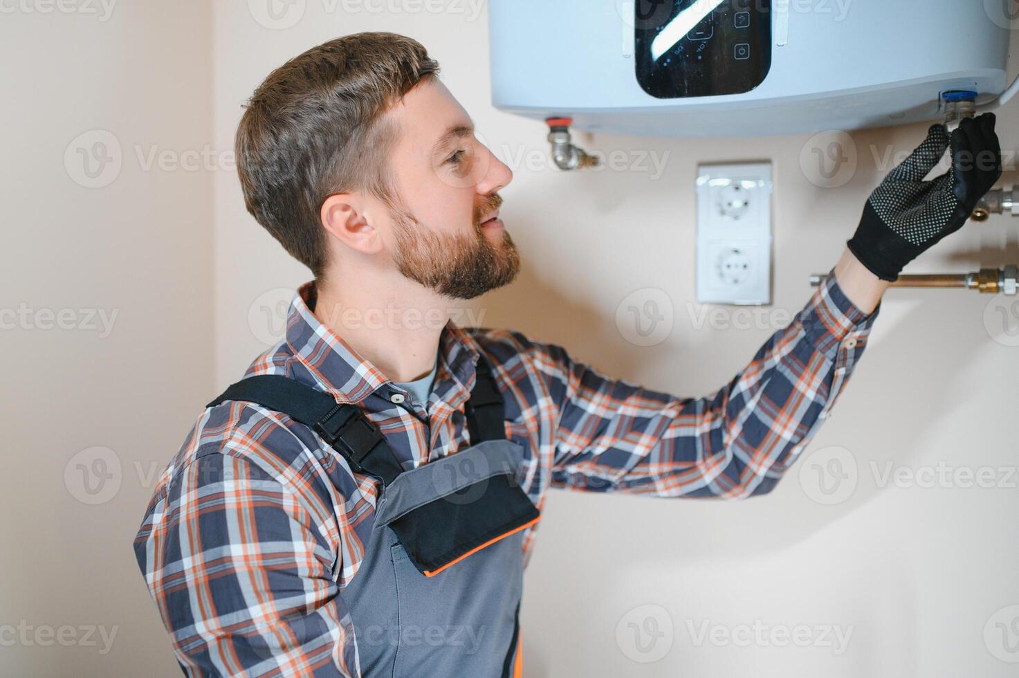 Professional plumber checking a boiler and pipes, boiler service concept photo